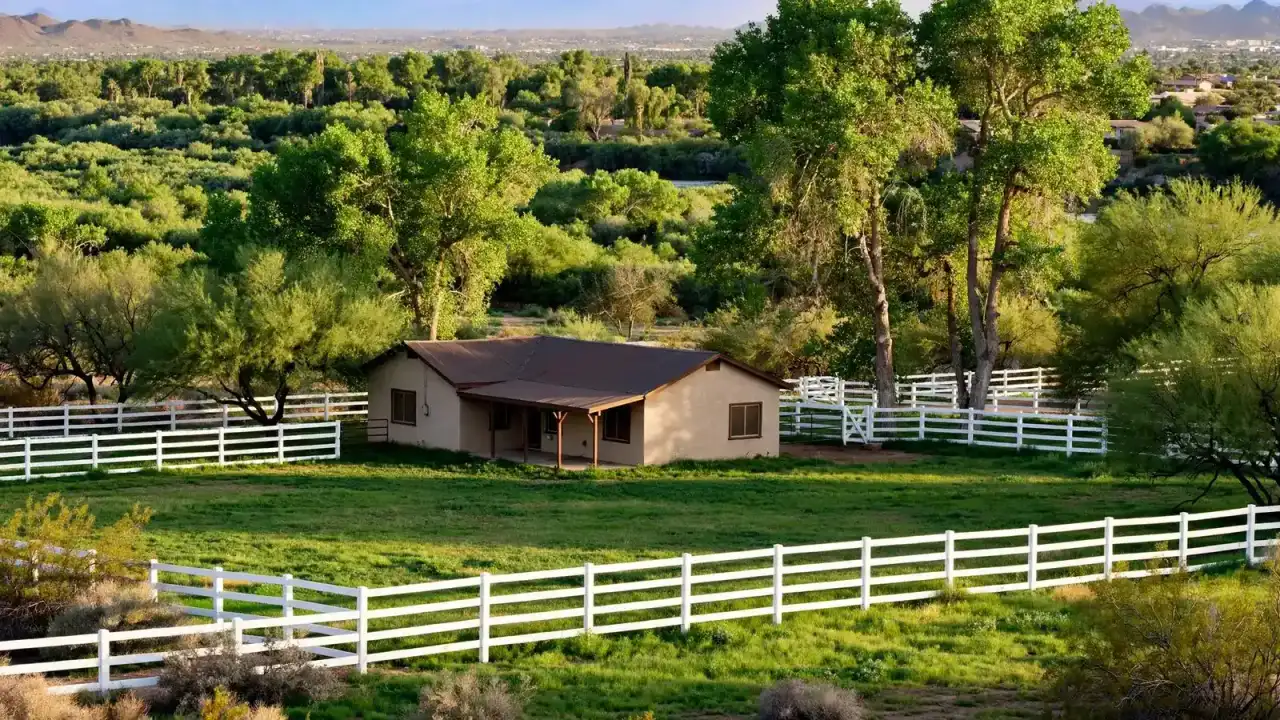 Older ranch property with horse fencing, irrigated pasture and mature trees near a river