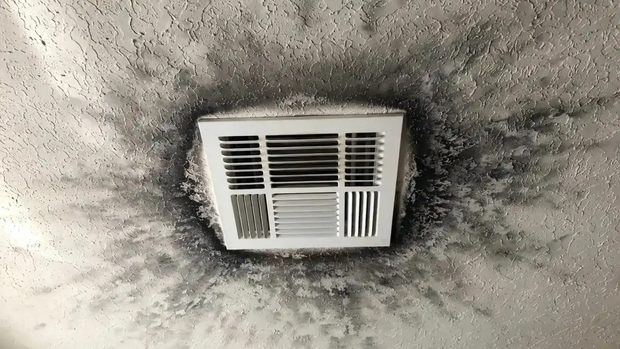 Ceiling air register with a dark ring of smoke residue